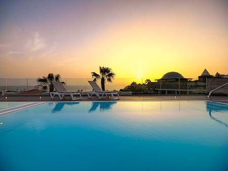 Colon Guanahani Hotel sun roof pool at sunset